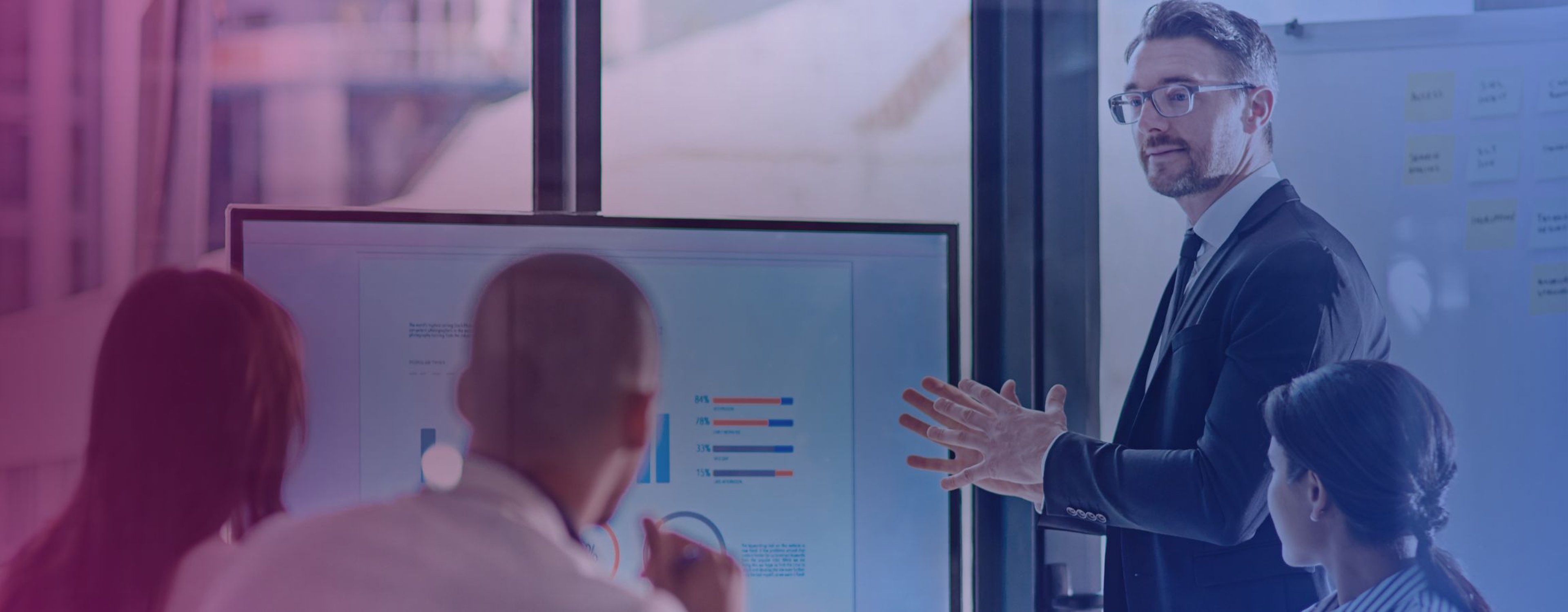 Stock image of a business meeting with an employee showing a presentation