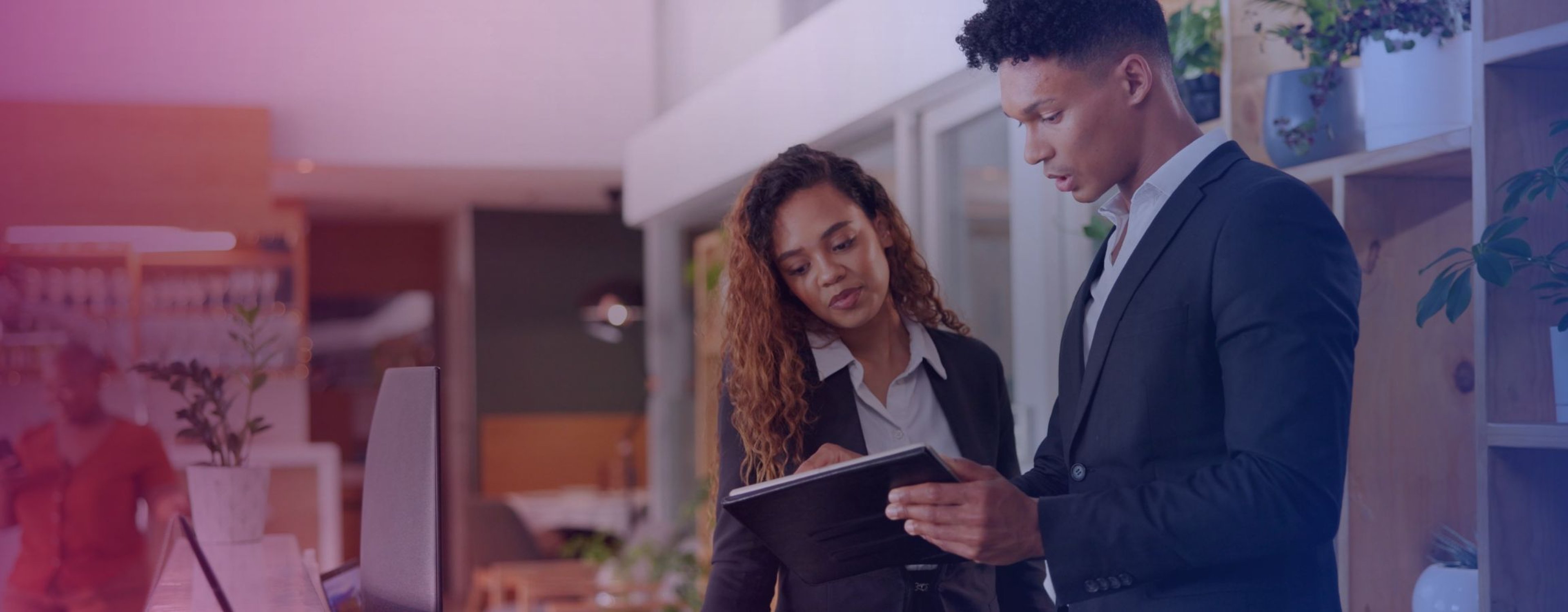 Hospitality workers looking at an electronic tablet together