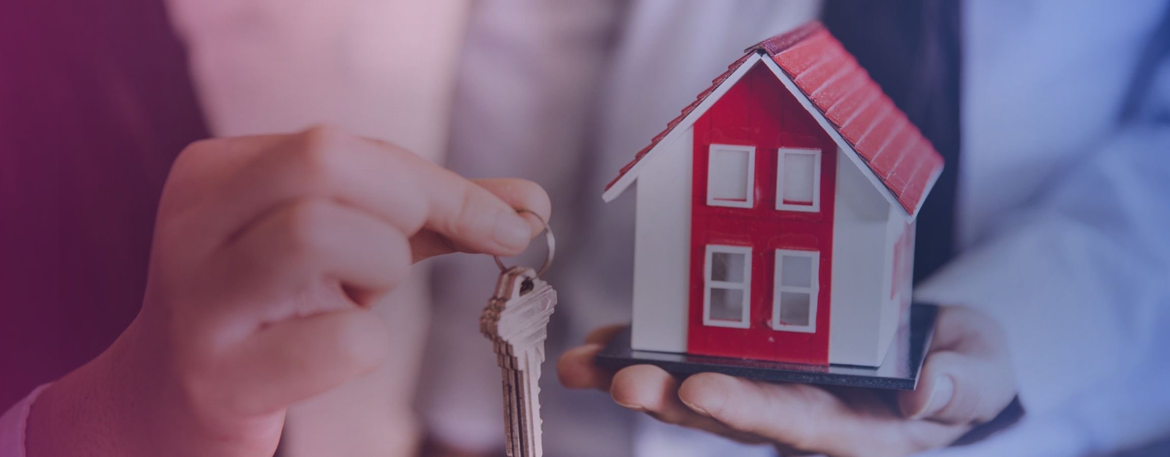 A person holding a set of house keys after closing on a deal