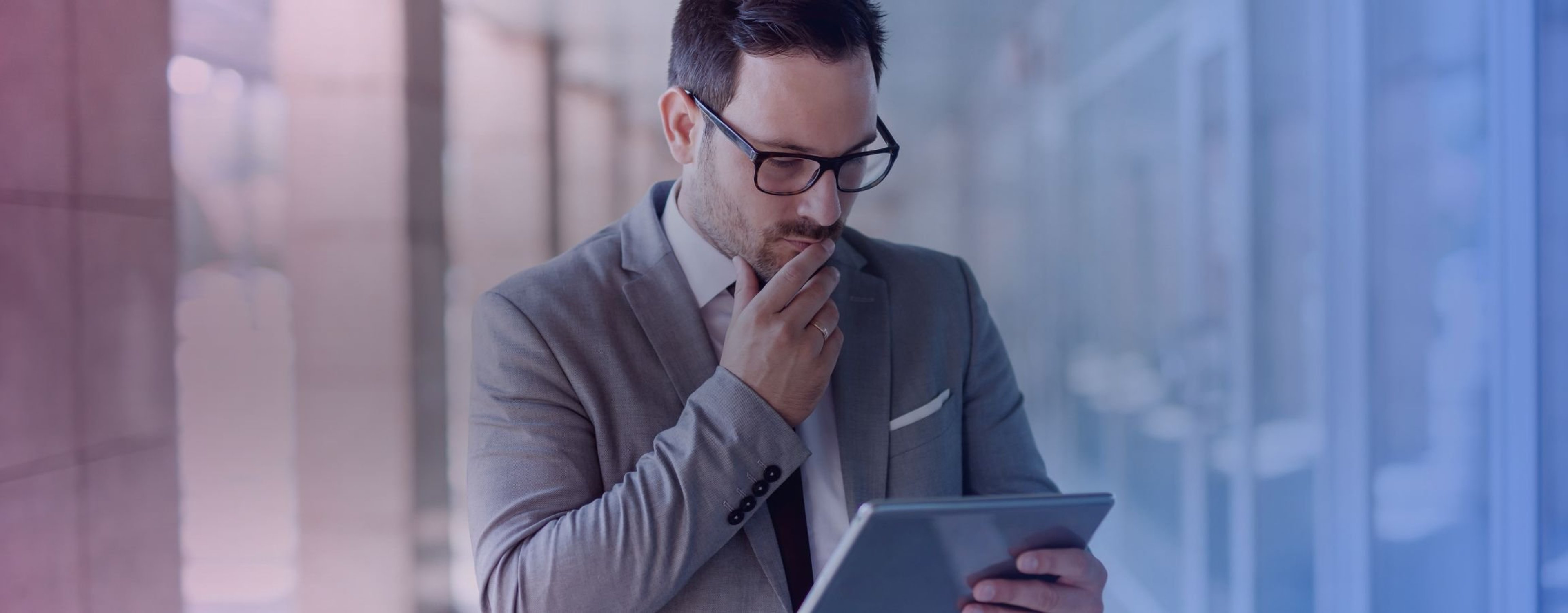 A businessman looking concerned at his electronic tablet