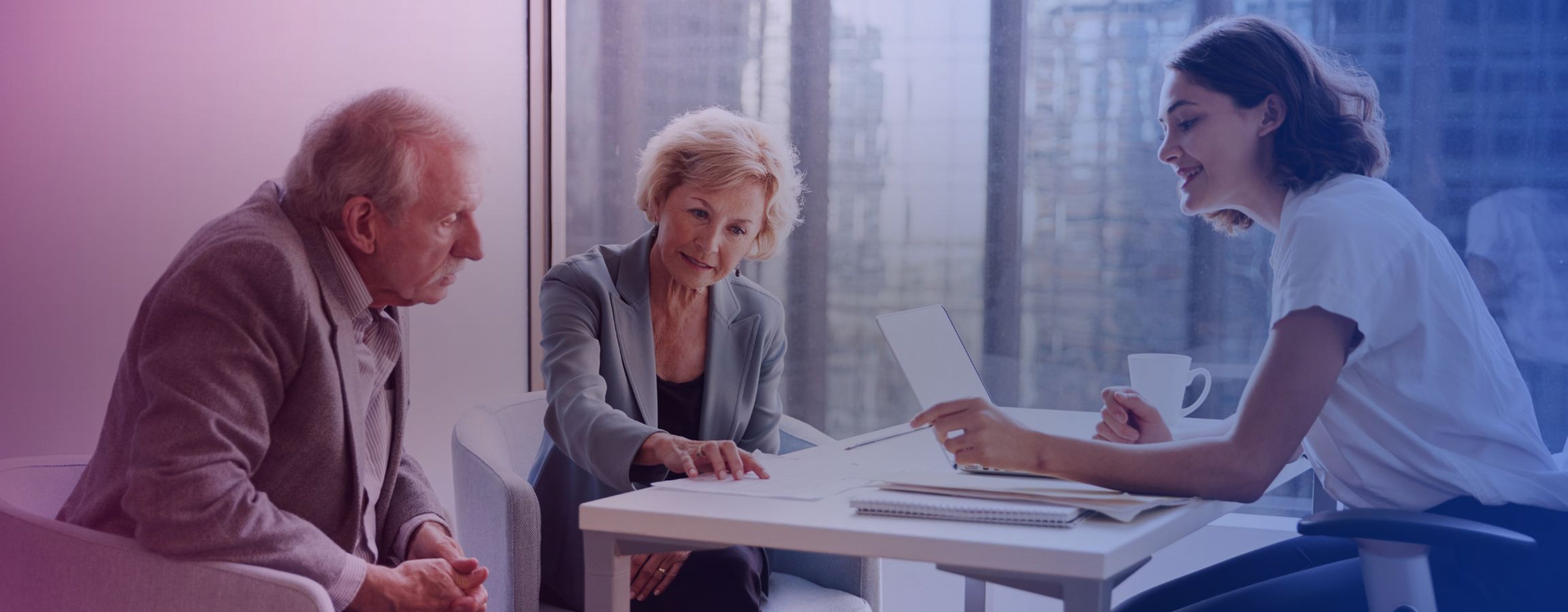 Senior Couple Meeting With Financial Advisor In Office