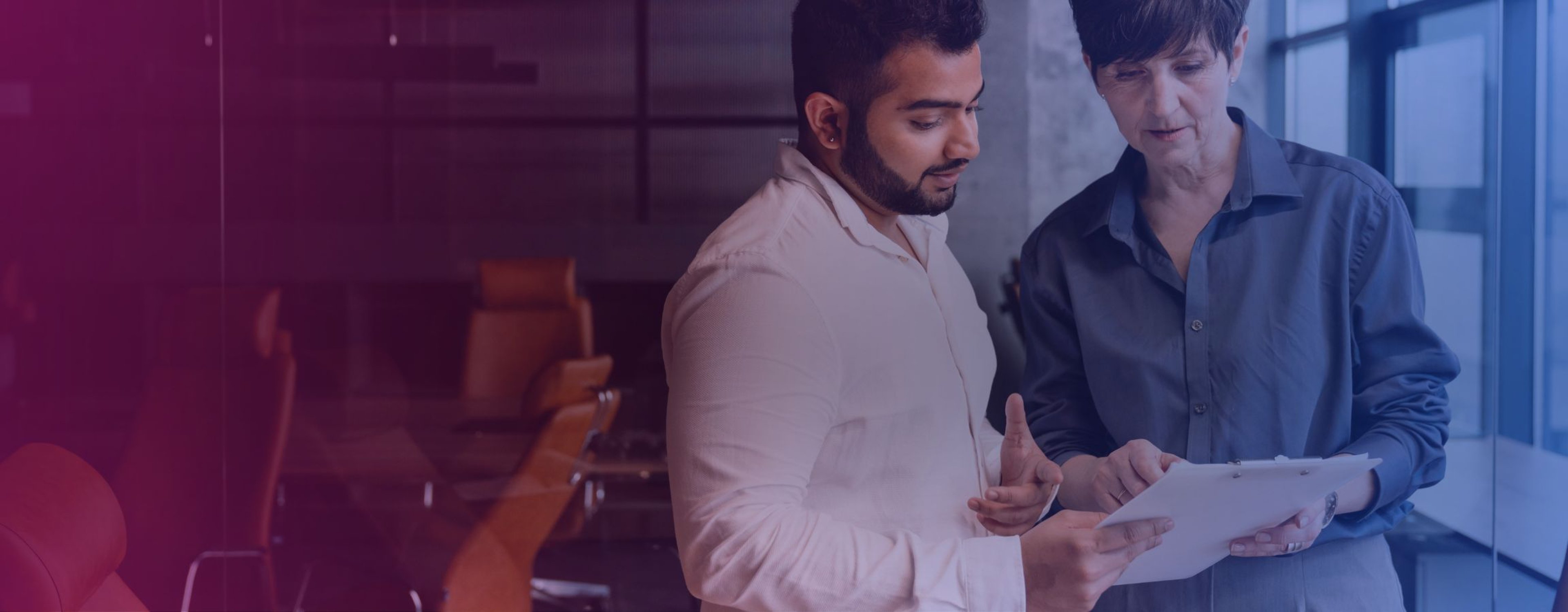 Two colleagues looking at a document together