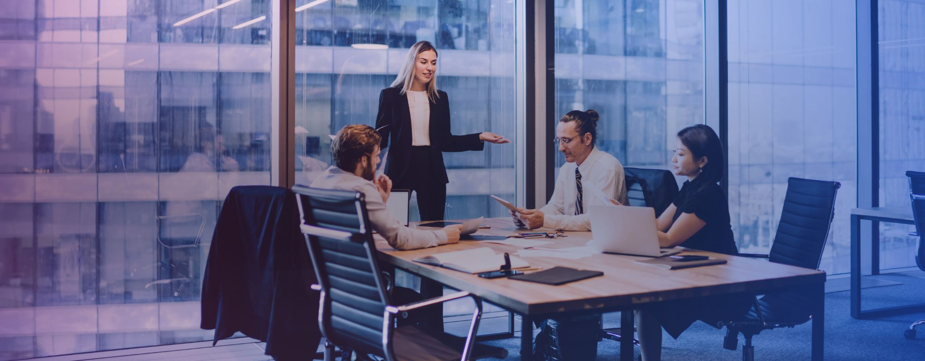Business employees sat around a meeting table working